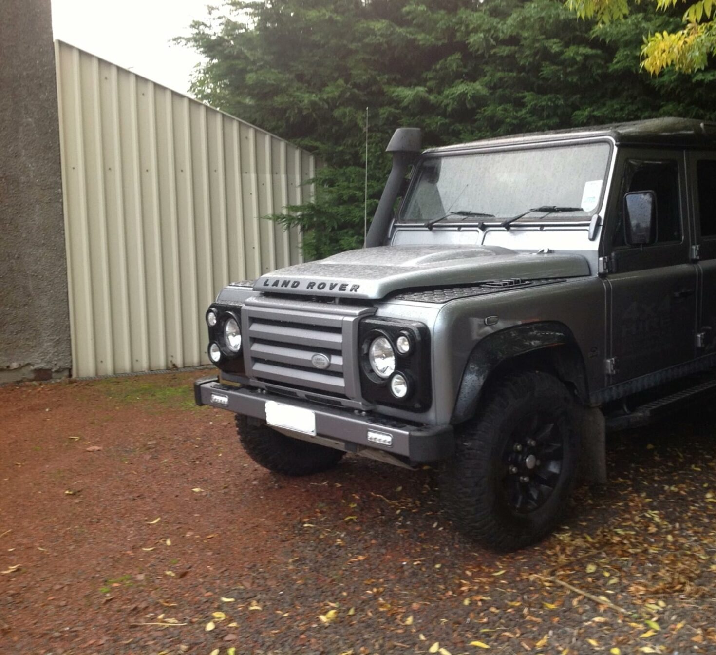 Land Rover Defender parked beside the workshop