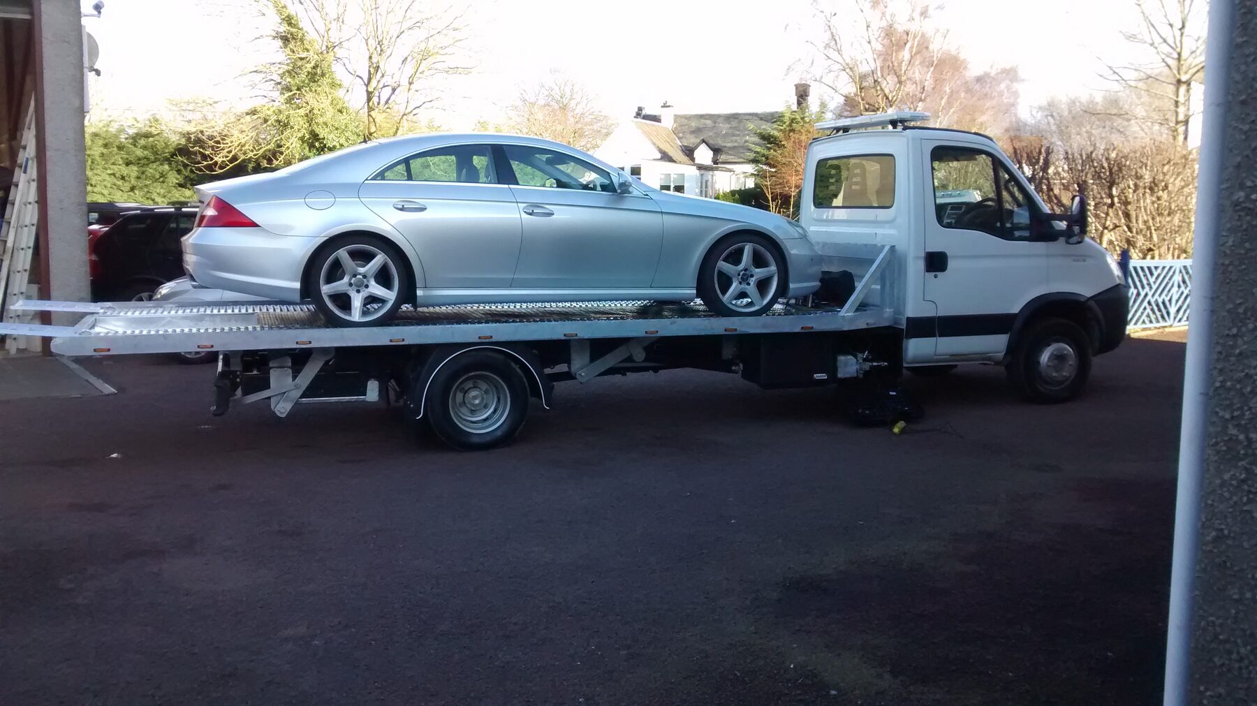 Recovery truck with a car loaded on the back